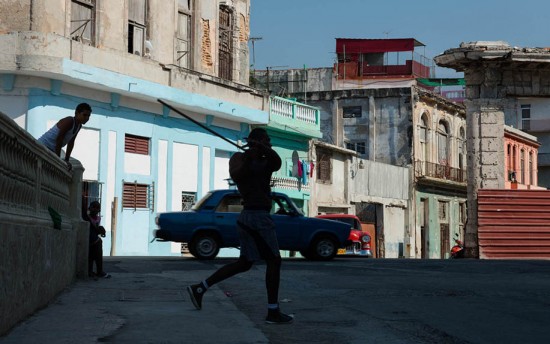 Havana, Cuba: Teenagers play baseball with a bottle cap and stick